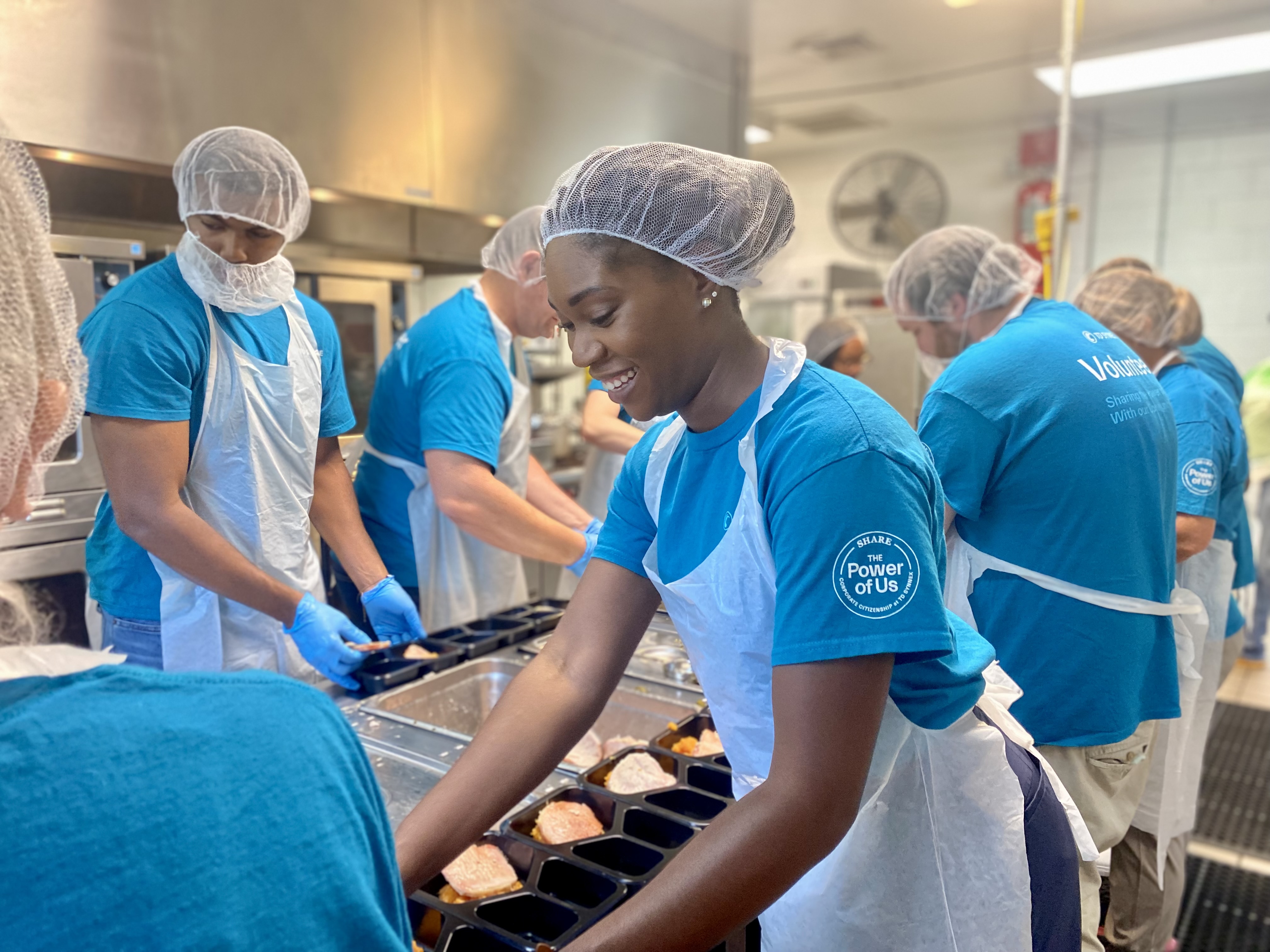TD SYNNEX co-workers in Greenville, South Carolina volunteering at Meals on Wheels working in a kitchen together.