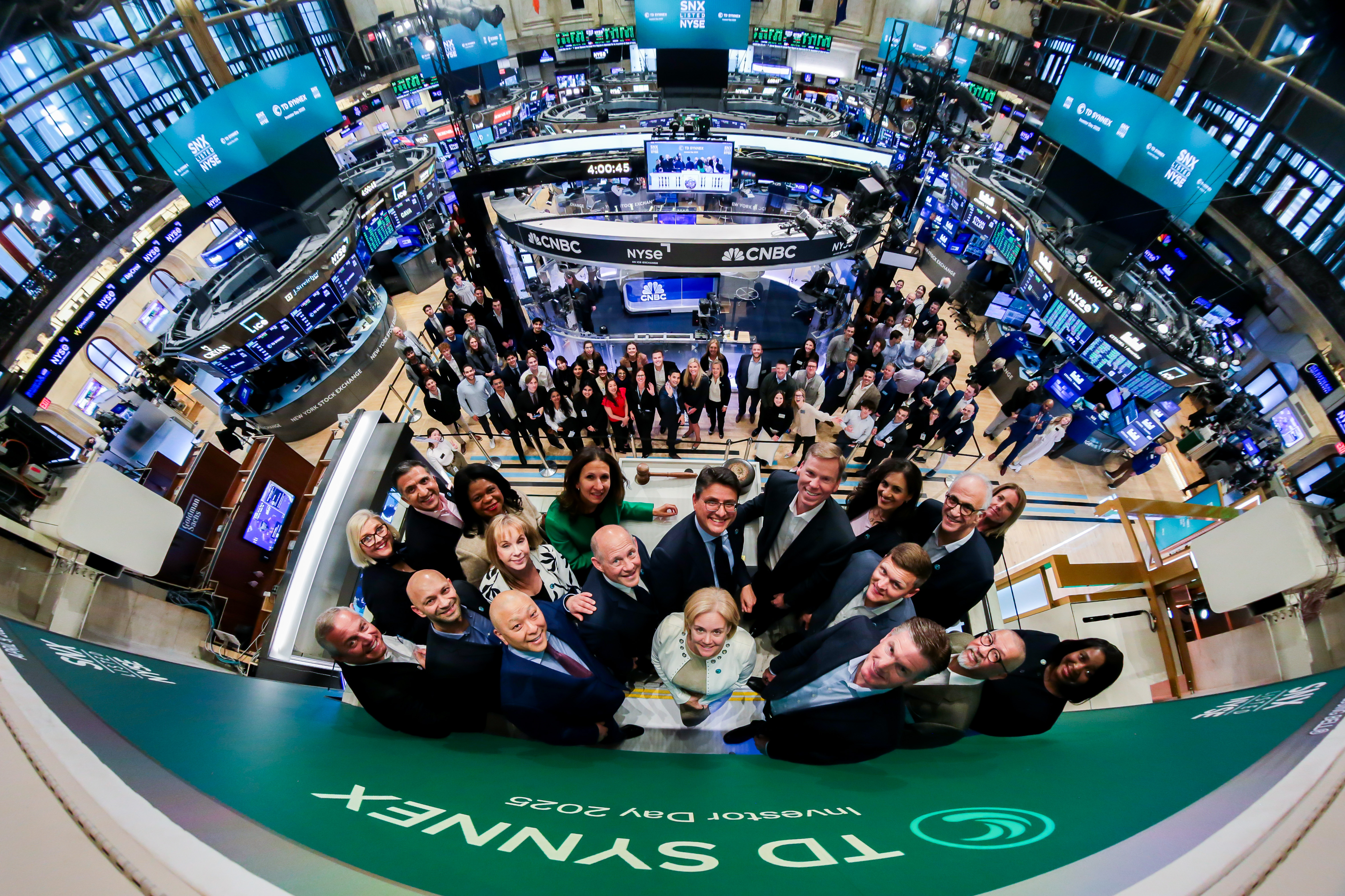 TD SYNNEX executive leadership team poses on stage after ringing the New York Stock Exchange closing bell together on the floor of the NYSE.
